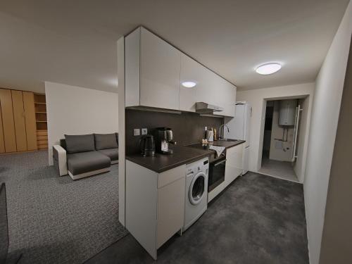 a kitchen with a washer and dryer in a room at Apartments Merci in Ostrava