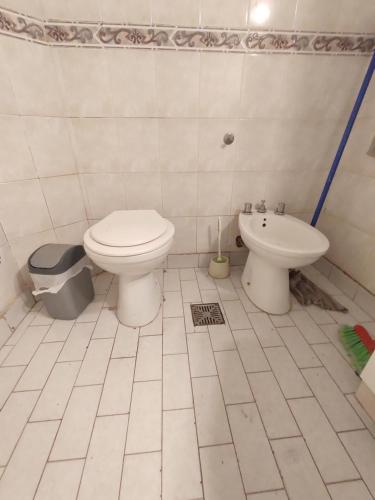 a bathroom with a toilet and a sink at Casa Paraiso in Presidente Roque Sáenz Peña