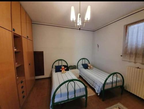 מיטה או מיטות בחדר ב-Affittacamere Villa Sofia con uso cucina e ampio giardino