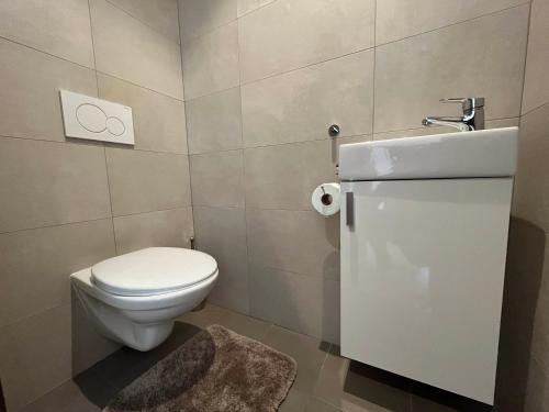 a bathroom with a toilet and a sink at Elegant Escape Apartment I - City Centre & Free Parking in Bratislava