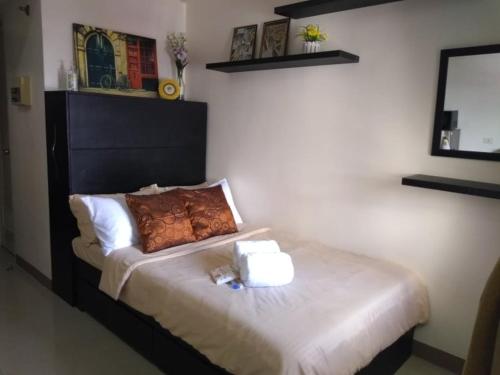 a bedroom with a bed with two towels on it at Mabolo Garden Flats in Cebu City