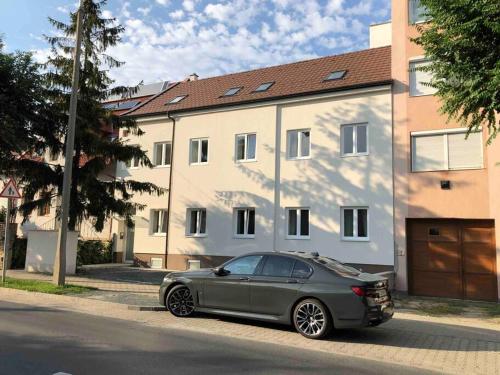 une voiture grise garée devant une maison dans l'établissement Quattro Casa, à Sopron