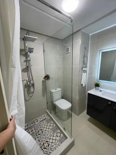 a bathroom with a shower with a toilet and a sink at Studio SvEt in ParC Mohammedia in Mohammedia