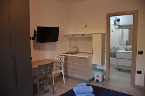 a small kitchen with a table and a counter top at B&B Alba Chiara in Paola