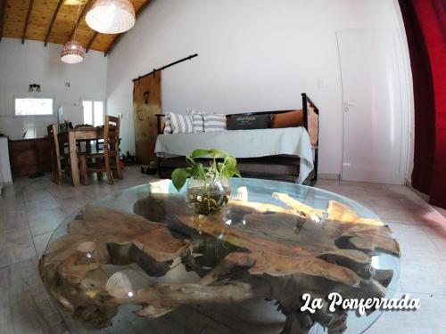 a living room with a table made out of a log at La ponferrada in Villa Ventana
