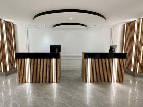 a lobby with two podiums in front of a wall at The Vic, Ascend Hotel Collection in Victoria