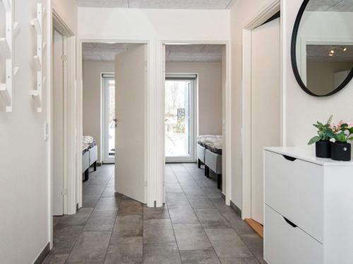un corridoio con 2 letti e uno specchio di Holiday home Ringkøbing LXXX a Ringkøbing
