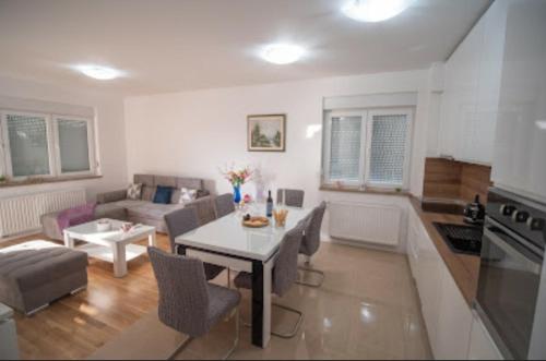 a living room with a table and a couch at Apartman San in Posušje