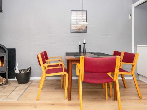 a dining room with a table and chairs and a fireplace at Tranquil Retreat in Skaerbaek - By Traum Ferienwohnungen in Skærbæk