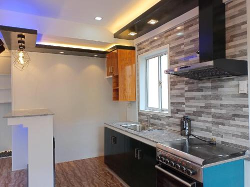 a kitchen with a sink and a stove at Camella Homes in Tagbilaran City