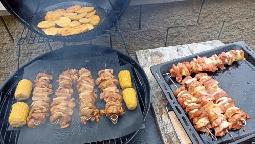 a bunch of food is cooking on a grill at Penzion U Halířů in Mladé Buky