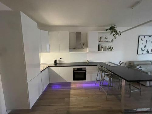 a kitchen with a table and chairs in a room at Palm beach appartment 80 mt dal mare e comodo per Venezia in Lido di Jesolo