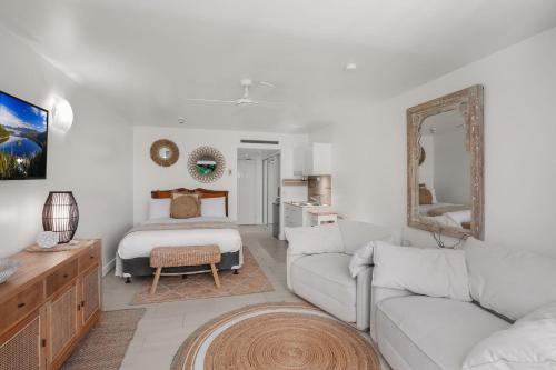 a living room with a couch and a bed at Belle Escapes Drift Beachfront Resort Suite 3409 in Palm Cove
