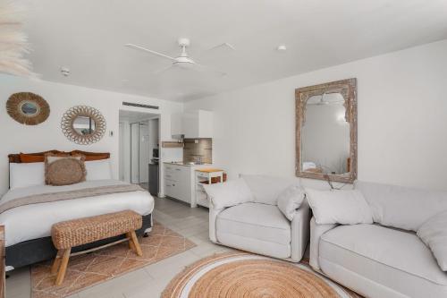 a living room with a couch and a bed at Belle Escapes Drift Beachfront Resort Suite 3409 in Palm Cove