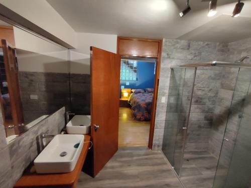 a bathroom with a sink and a shower at linda house cusco in Cusco