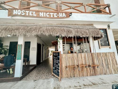 a restaurant with a sign that reads hostel niche hog at Hotel Nicte Ha Tulum in Tulum