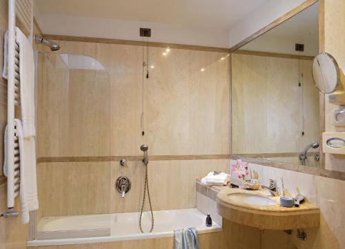 a bathroom with a tub and a sink and a shower at Hotel Kette in Venice