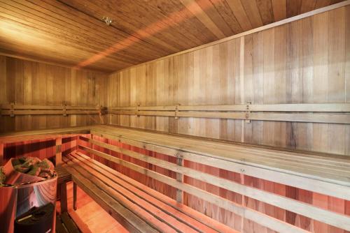 a empty sauna with wooden walls and wooden floors at Oceanside Apartment with Garden Views in Mount Maunganui