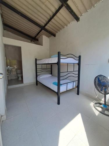 a bedroom with a bunk bed in a room at Mar Rosa Galerazamba Hostal in Galerazamba