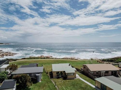 an aerial view of the ocean and houses at OceanFront - Absolute Waterfront in Bicheno