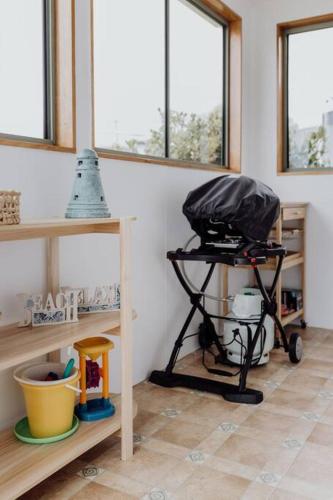 a room with a cart in a room with windows at OceanFront - Absolute Waterfront in Bicheno