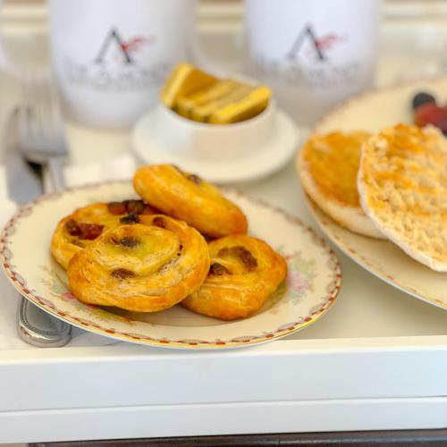 three pastries on a plate on a table at Almondy Inn Bed & Breakfast in Newport