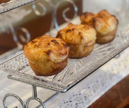 three muffins on a cooling rack on a shelf at Almondy Inn Bed & Breakfast in Newport