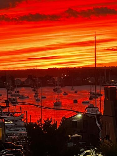 a sunset over a marina with boats in the water at Almondy Inn Bed & Breakfast in Newport