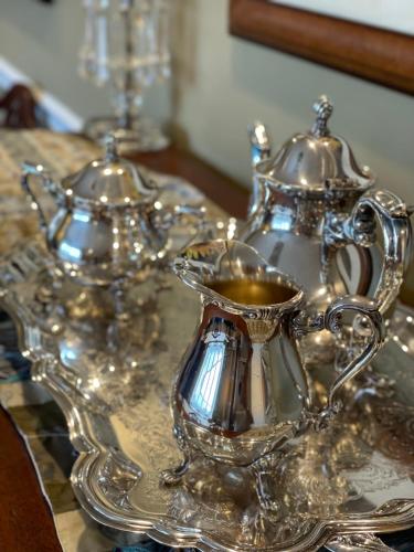 a silver tray with a tea set on a table at Almondy Inn Bed & Breakfast in Newport