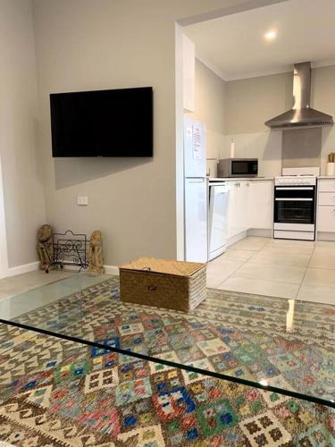 a kitchen with a glass table in the middle of a room at Kiama Tea House in Bicheno