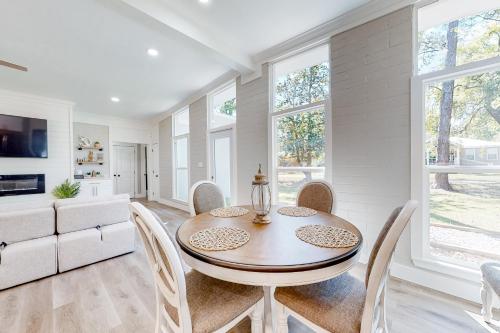 a dining room with a table and chairs at Hidden Treasure in Dauphin Island