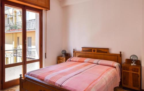 een slaapkamer met een bed en een groot raam bij Beautiful Apartment In Montepaone With 3 Bedrooms in Montepaone