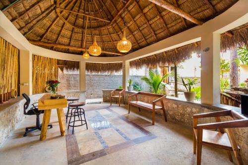 a lobby of a resort with a table and chairs at Jaakbal Tulum in Tulum