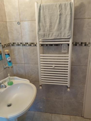 a bathroom with a sink and a towel hanging on a towel rack at AzulTDF C in Ushuaia