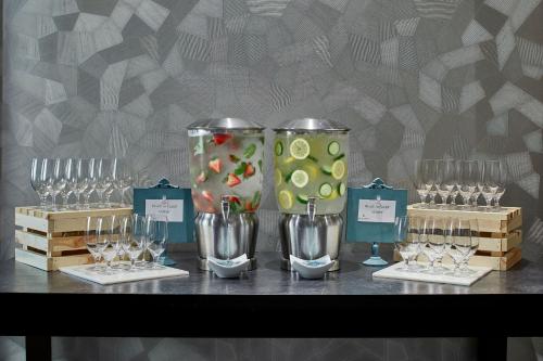 a table with glasses and wine glasses and wine bottles at Renaissance Atlanta Midtown Hotel in Atlanta