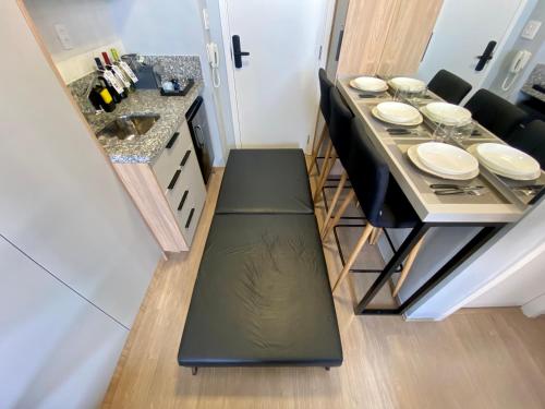 a small kitchen with a dining room table with plates on it at MV 148B Fantástico Apartamento Em Frente Ao Metrô Brás ! - Rua Coronel Mursa, 56 - Bras in Sao Paulo