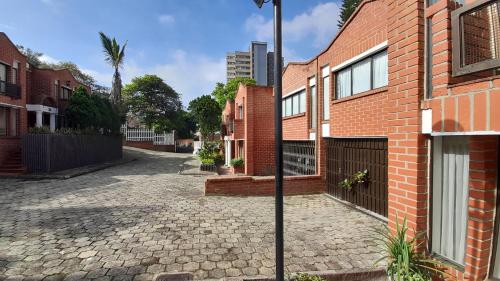 an empty street in front of a brick building at Aparta estudio moderno in Envigado