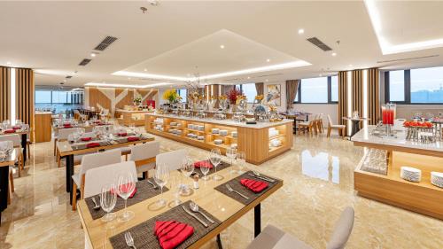 a restaurant with tables and chairs and a bar at Selegend Hotel Thái Bình in Thái Bình