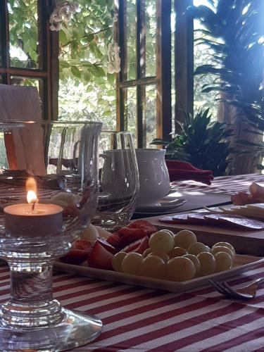 a table with a candle and wine glasses on it at Cabañas Puente Negro in Puente Negro