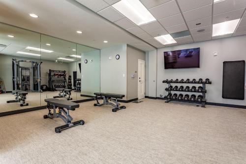 a gym with treadmills and chairs in a room at TownePlace Suites by Marriott Raleigh - University Area in Raleigh