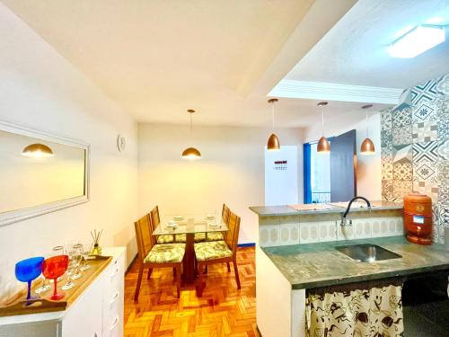 a kitchen with a table and a dining room at Casa charmosa no Centro Histórico com garagem in Ouro Preto