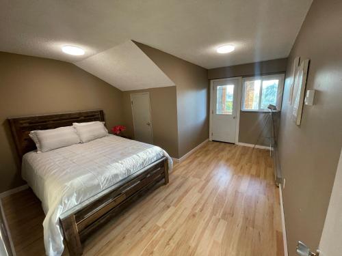 a bedroom with a bed and a staircase in it at 3-Bedroom Apartment in 108 Mile Ranch
