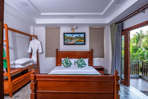 Ένα ή περισσότερα κρεβάτια σε δωμάτιο στο Ganesha Kampot Resort