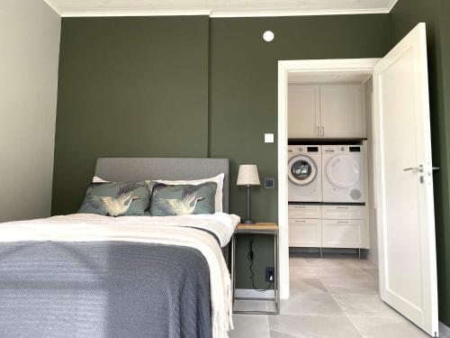 a bedroom with a bed and a washing machine at 8 person holiday home in UDDEVALLA-By Traum in Sundsandvik