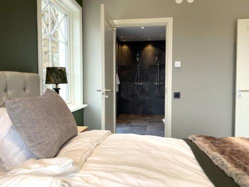 a bedroom with a bed and a walk in shower at 8 person holiday home in UDDEVALLA-By Traum in Sundsandvik