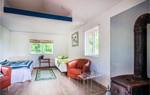 a living room with a bed and a couch at Cozy Home In Torup With Kitchen in Torup