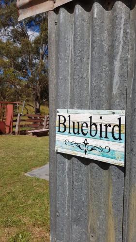 a sign on a pole with a bluebird sign on it at Tiny Home - Bluebird in Hartley