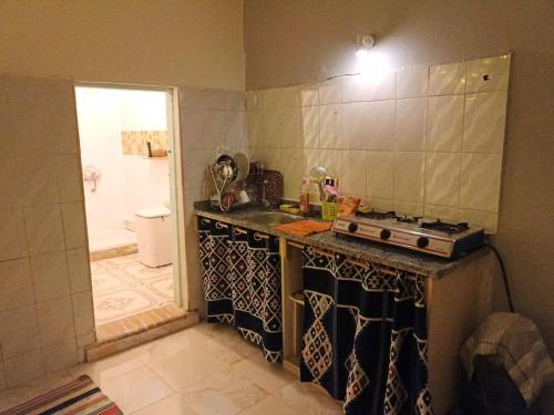 a kitchen with a sink and a stove in it at Bougainvillea studio in Dahab