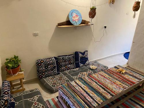 a living room with a bed and a couch at Bougainvillea studio in Dahab