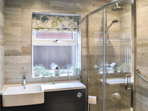 a bathroom with a sink and a shower at Sea Shells in Sutton on Sea